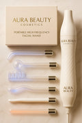 Aura Beauty High-Frequency Facial Wand with four glowing blue electrode attachments displayed on white marble background — luxury skincare device.