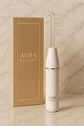 Aura Beauty High-Frequency Facial Wand with four glowing blue electrode attachments displayed on white marble background — luxury skincare device.